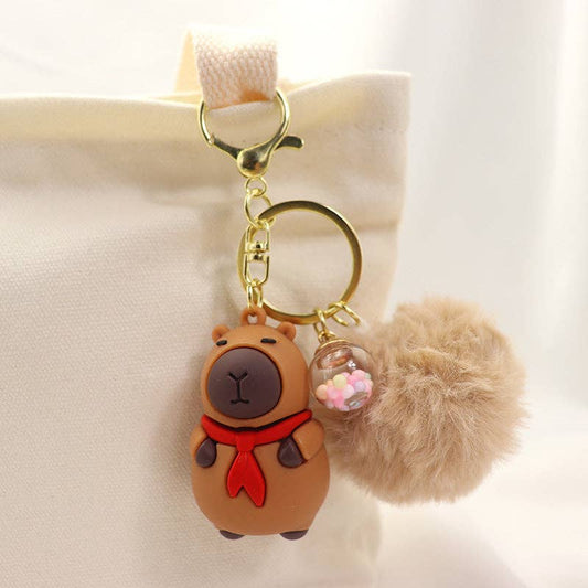 Rosa Capybara Nyckelring Pompom - Kawaii Design med Halsduk/Kamera